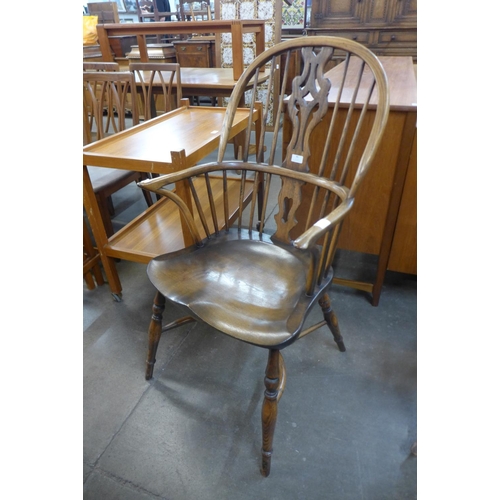 86 - An elm and beech highback Windsor armchair