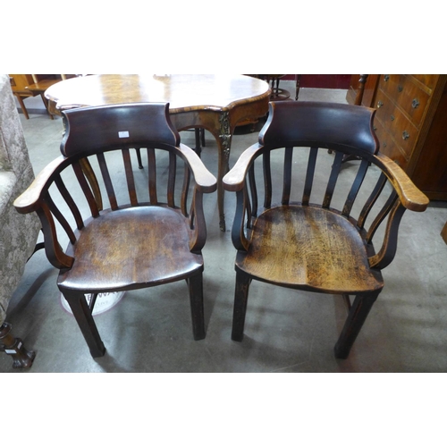 87 - A pair of early 20th Century oak office desk chairs