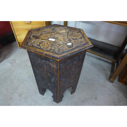 91 - An Arts and crafts carved cedar wood hexagonal table