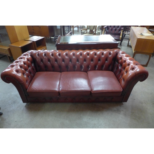 93 - A red leather Chesterfield settee