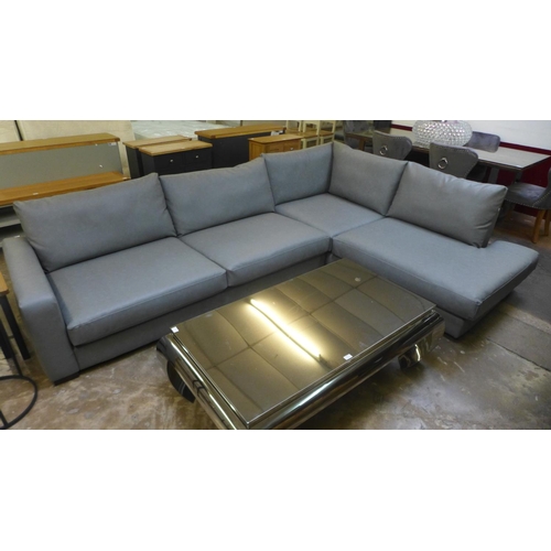 1534 - A grey faux leather corner sofa (repair to rear)