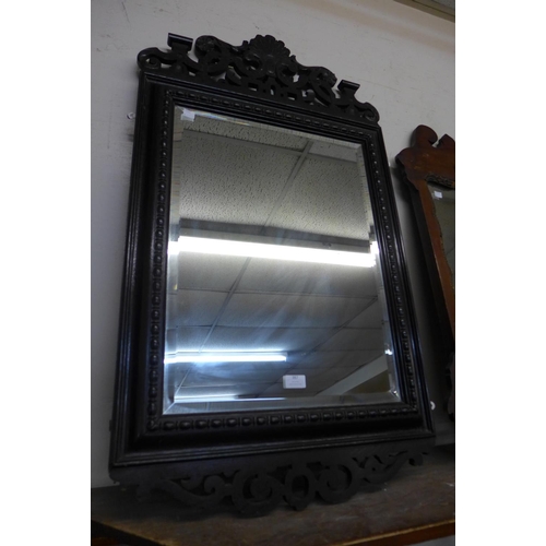 387 - A Victorian carved oak mirror