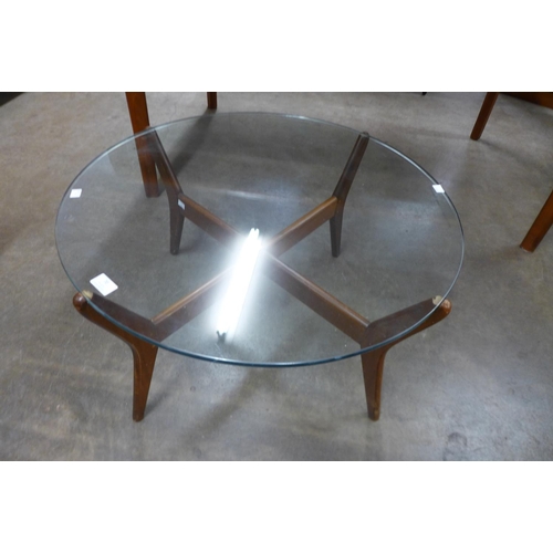 70 - A teak and glass topped circular coffee table