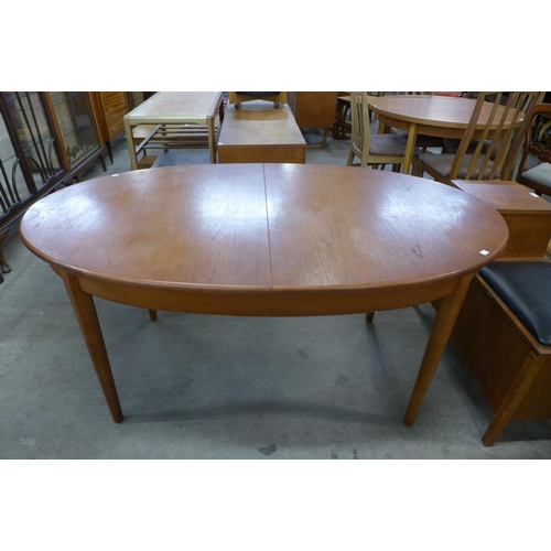 83 - A teak extending dining table