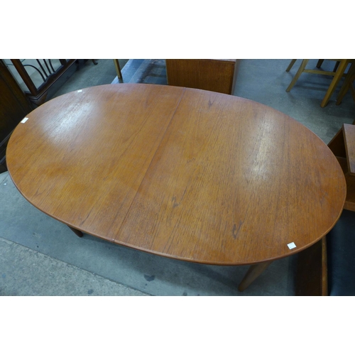 83 - A teak extending dining table