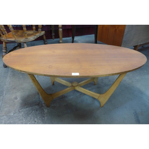 84 - A teak oval coffee table