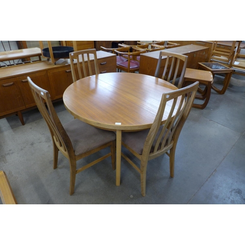 87 - A teak extending dining table and four chairs