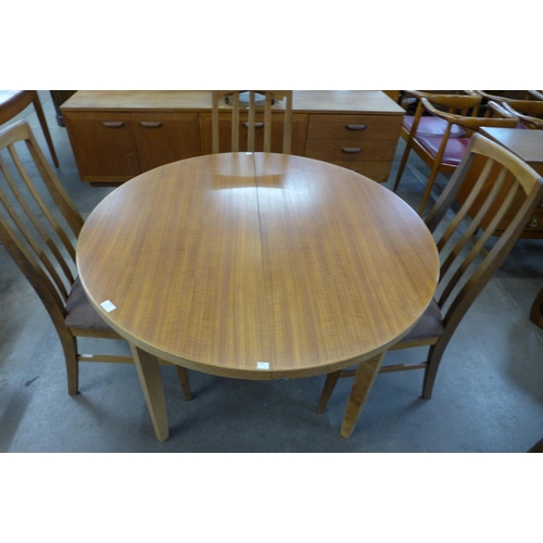 87 - A teak extending dining table and four chairs