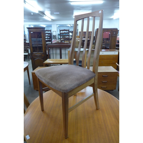 87 - A teak extending dining table and four chairs