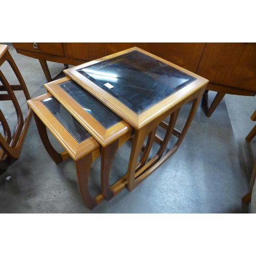 89 - A teak and glass topped nest of tables