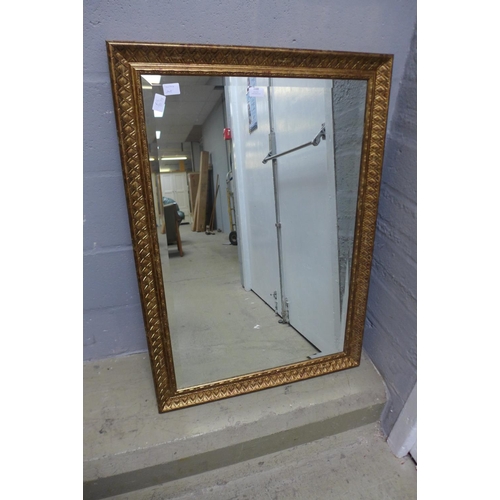 1688 - A rectangular bevelled framed mirror