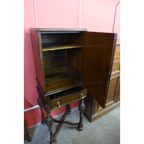 10 - A 17th Century style carved oak cabinet on stand