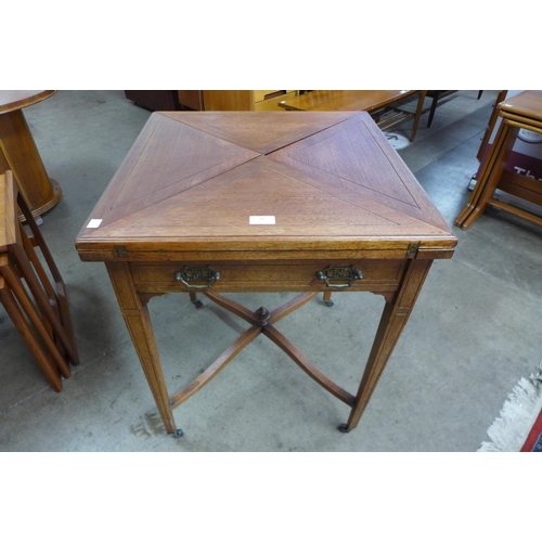 12 - An Edward VII mahogany envelope card table, stamped W. Walker & Sons, Bunhill Row, London E.C.