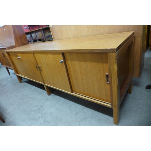 117A - A teak sliding two door sideboard