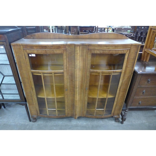 130 - A walnut bow front bookcase