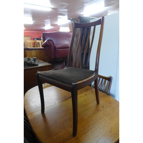 100 - A teak extending dining table and four chairs