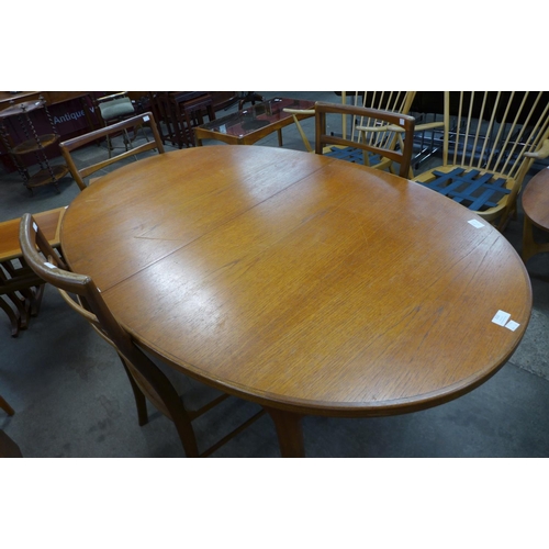 112 - A teak extending dining table and four chairs