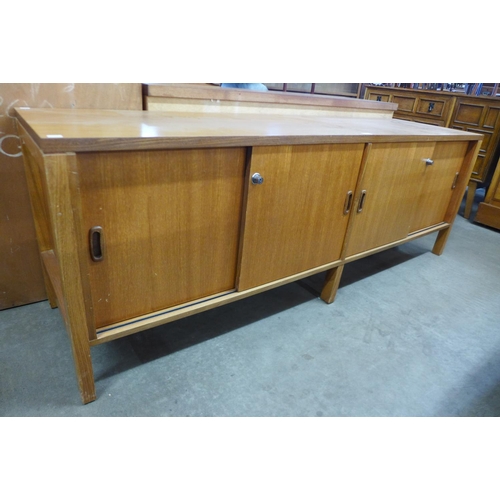 117A - A teak sliding two door sideboard