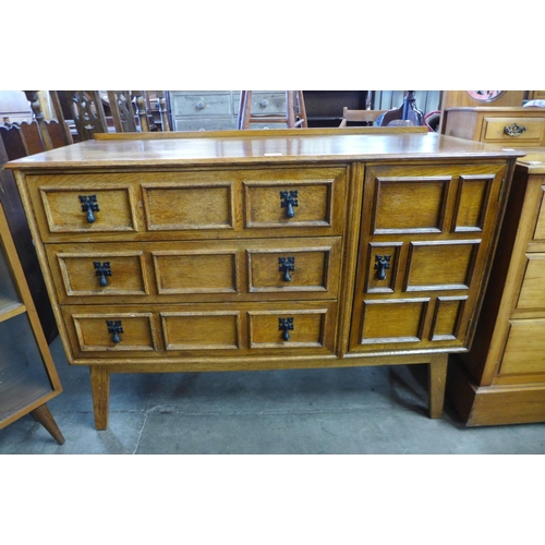 127 - A small oak geometric moulded sideboard