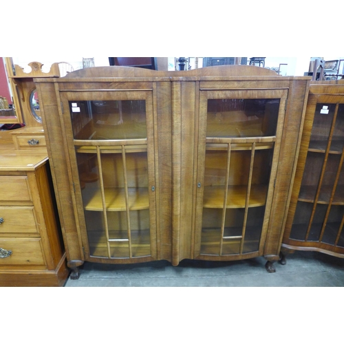 130 - A walnut bow front bookcase