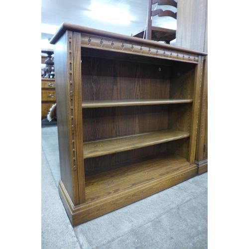 136 - An Ercol Golden Dawn elm open bookcase