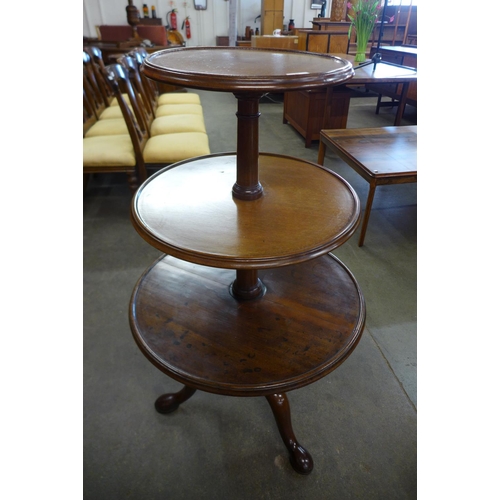 22 - A George III mahogany three tier circular dumb waiter