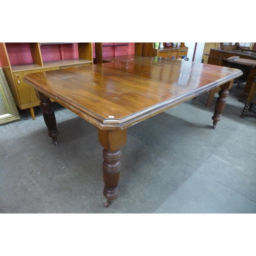 25 - A Victorian walnut extending dining table