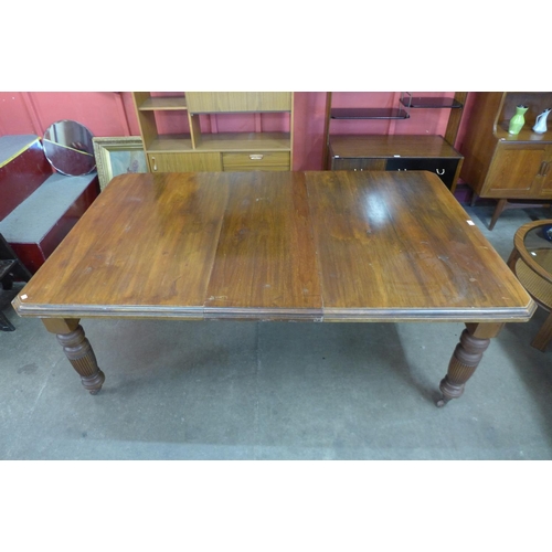 25 - A Victorian walnut extending dining table