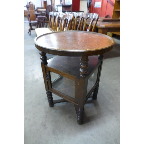 26 - An early 20th Century oak circular bobbin display table