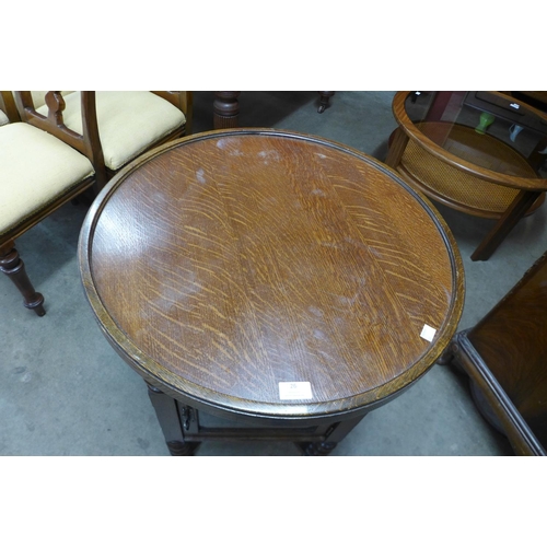 26 - An early 20th Century oak circular bobbin display table