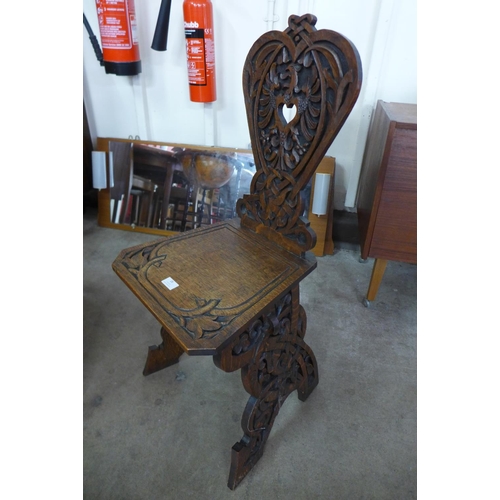 28 - A Victorian carved oak hall chair