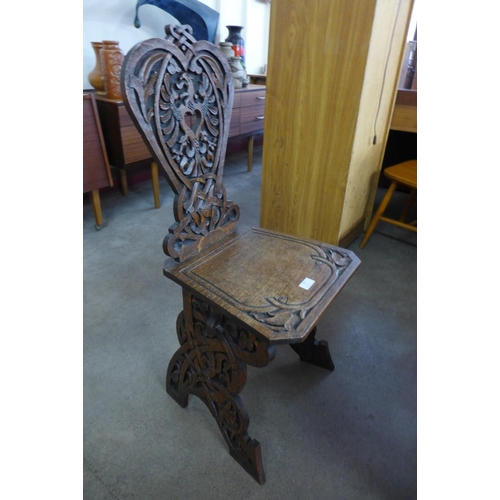 28 - A Victorian carved oak hall chair