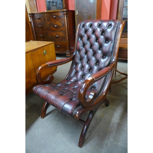 37 - A mahogany and ox blood leather open armchair