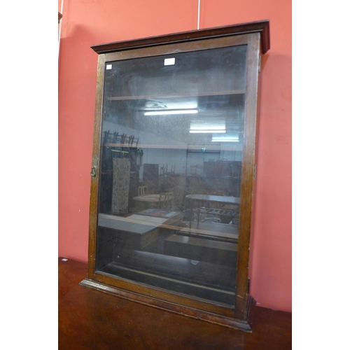 4 - An early 20th Century oak wall hanging display cabinet