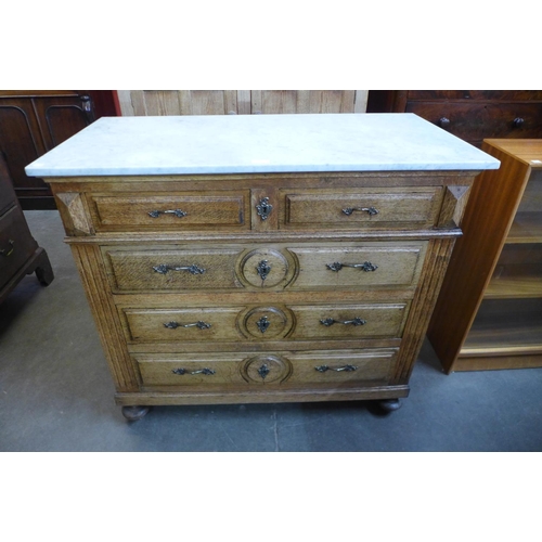 7 - A French provincial oak and marble topped commode