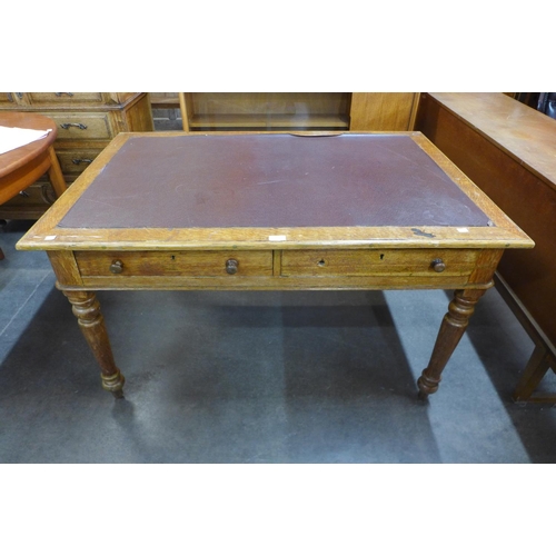 8 - A Victorian oak two drawer library table