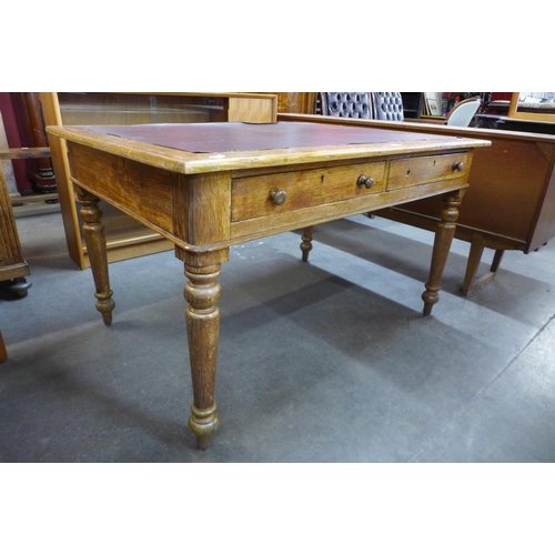 8 - A Victorian oak two drawer library table