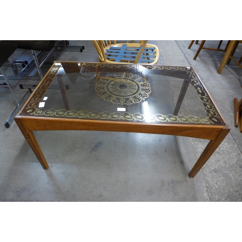 83 - A teak and glass top coffee table