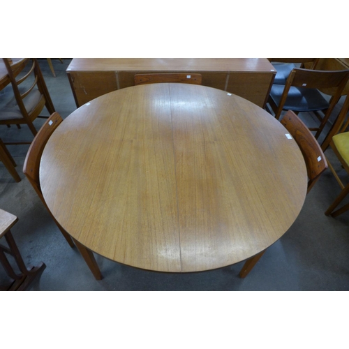 86 - A teak extending dining table and four chairs