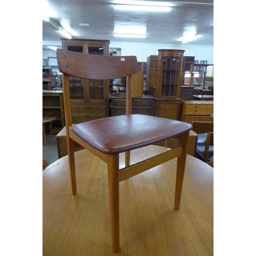 86 - A teak extending dining table and four chairs