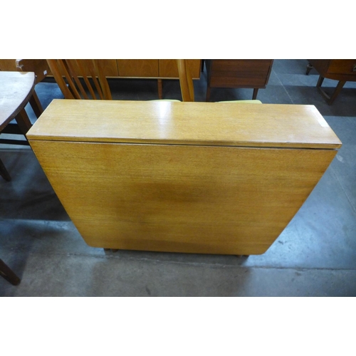 87 - A teak drop-leaf table and four chairs