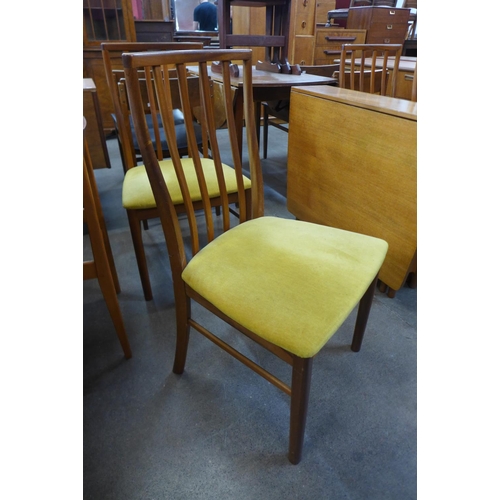 87 - A teak drop-leaf table and four chairs