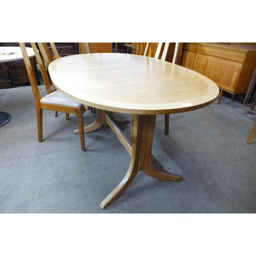 94 - A Nathan teak extending dining table and four chairs