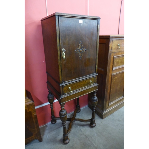 31 - A 17th Century style carved oak cabinet on stand