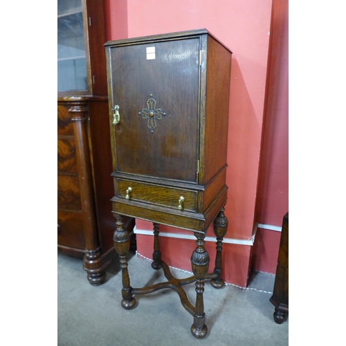 31 - A 17th Century style carved oak cabinet on stand