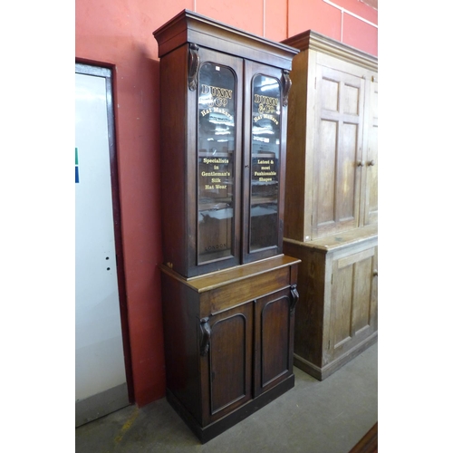 32 - A Victorian mahogany bookcase, bearing later Dunn & Co. Hat Makers, London inscription to doors