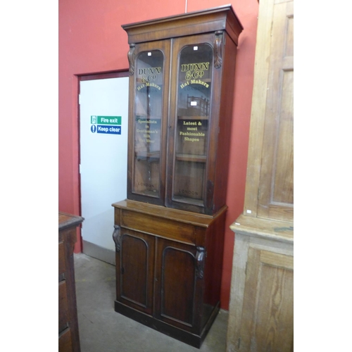 32 - A Victorian mahogany bookcase, bearing later Dunn & Co. Hat Makers, London inscription to doors