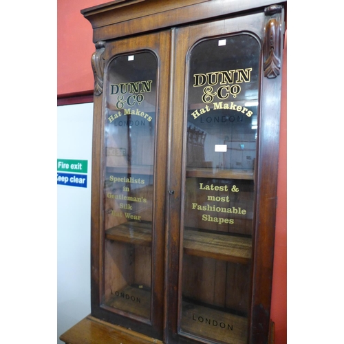 32 - A Victorian mahogany bookcase, bearing later Dunn & Co. Hat Makers, London inscription to doors