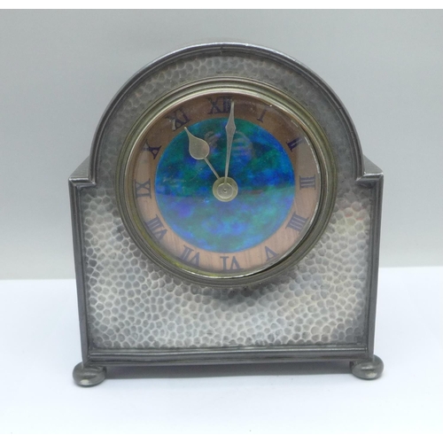 48a - A Liberty & Co. Arts and Crafts Tudric Pewter mantel timepiece, with turquoise enamelled dial, the m... 