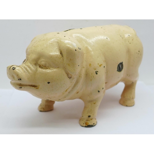 657 - A metal money box in the form of a pig, 21cm